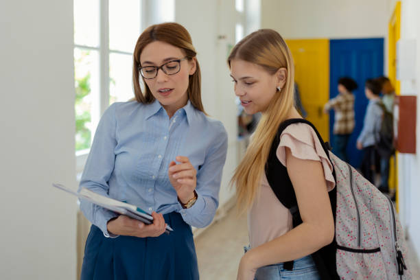istock Teacher Talking With School Girl Student 1640718517