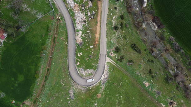 istock Winding road in the forest seen from above 1640736354