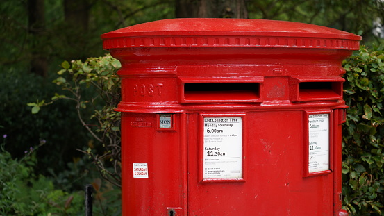 Red E&R Royal Mail letterbox built into stone wall of old building in Dundee, Scotland