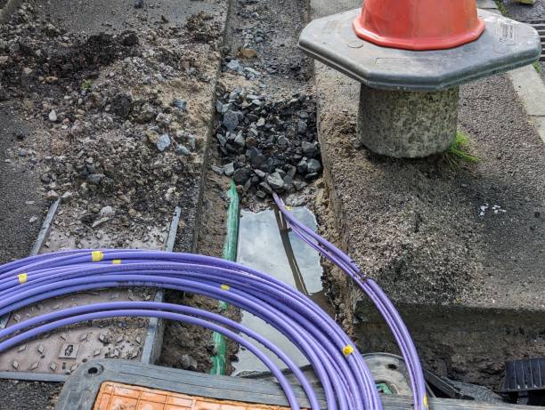 Fibre optic cable coming out of a trench Fibre optic cable coming out of a trench curled up waiting to be installed for the UK gigabit broadband rollout being installed by the internet service providers ISPs across the country. broadband isp stock pictures, royalty-free photos & images