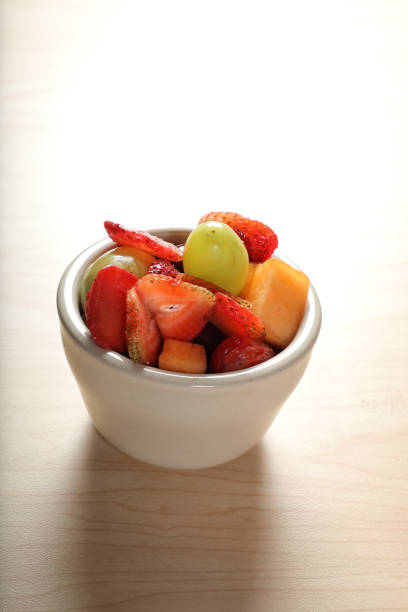 istock Close up mixed fruit plate on wooden table 1640783555
