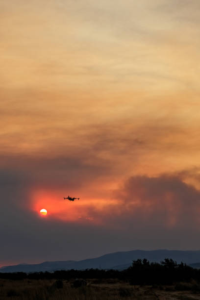 istock Devastating wildfire in Alexandroupolis Evros Greece, Aerial firefighting waterbombing planes, smoke covered the sky, sunset colors 1640788732