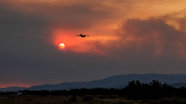 istock Devastating wildfire in Alexandroupolis Evros Greece, Aerial firefighting waterbombing planes, smoke covered the sky, sunset colors 1640789618