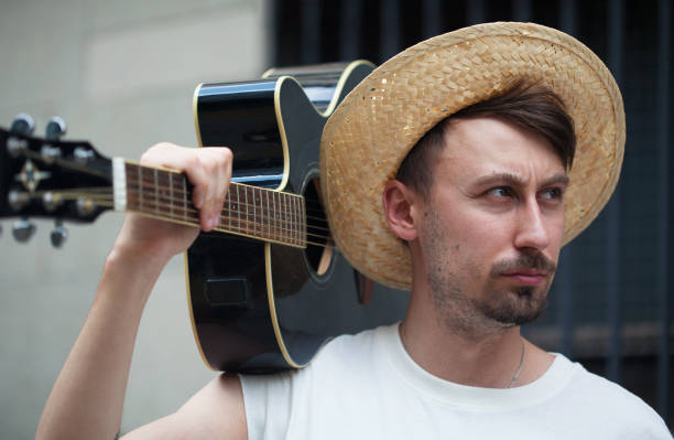 Musician carrying guitar on shoulder