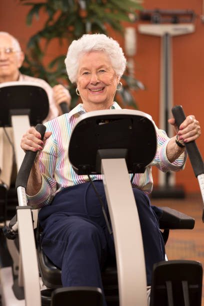 istock Seniors working out on exercise bike in gym 164081701