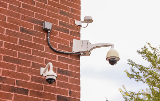 Security camera embodies vigilance, modern surveillance, privacy concerns, and a watchful society