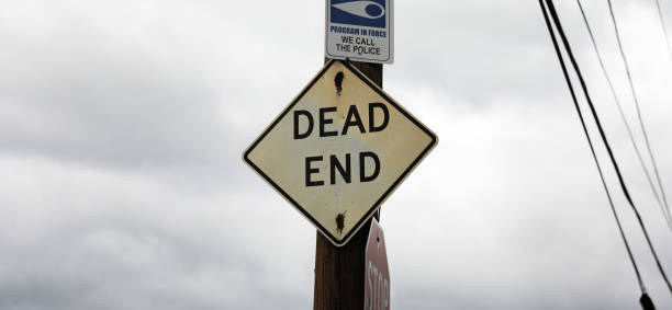 istock Dead End sign stands against a desolate backdrop, embodying finality, halted progress, and the need for redirection in life's journey 1640839246
