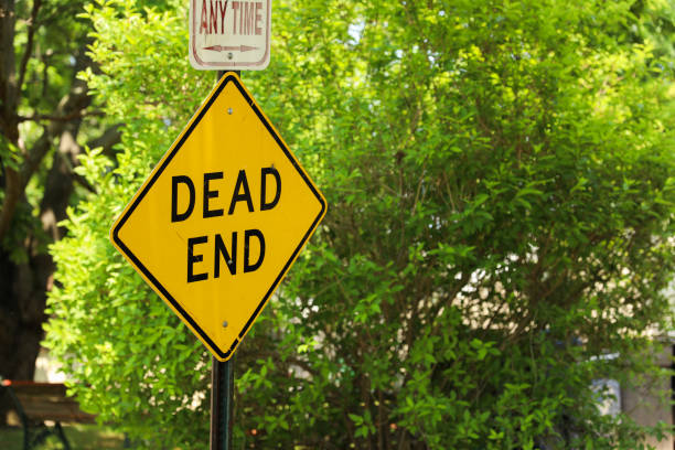 istock Dead End sign stands against a desolate backdrop, embodying finality, halted progress, and the need for redirection in life's journey 1640840283