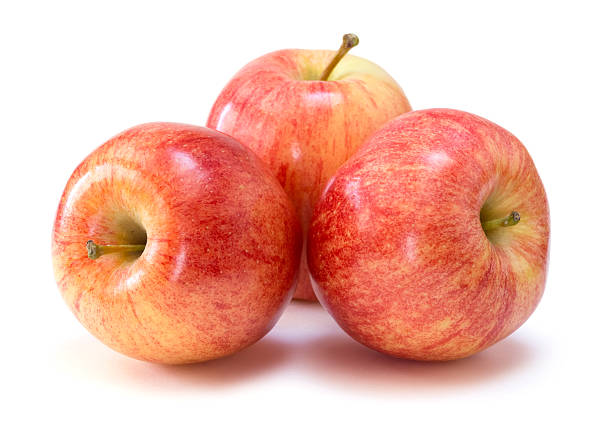 Three apples arranged in a bunch over a white background stock photo