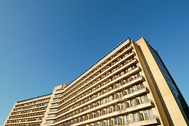 istock Large old abandoned hotel wide angle view clear blue sky 164089334