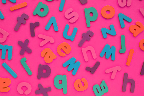 istock Color alphabet letters on pink background. World Dyslexia Day concept. Solving the educational problem of reading. Medical and mental health awareness. Logopedy, psychology, learning lessons 1640901466
