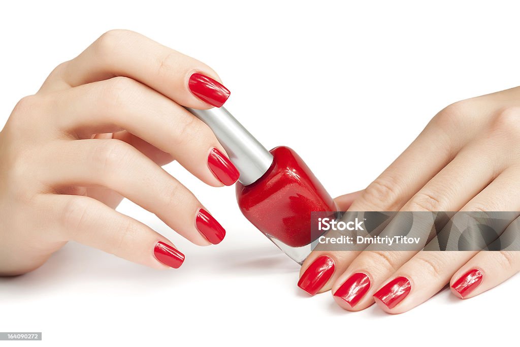 Hands with red manicure and nail polish bottle isolated Hands with red manicure and nail polish bottle Human Hand Stock Photo