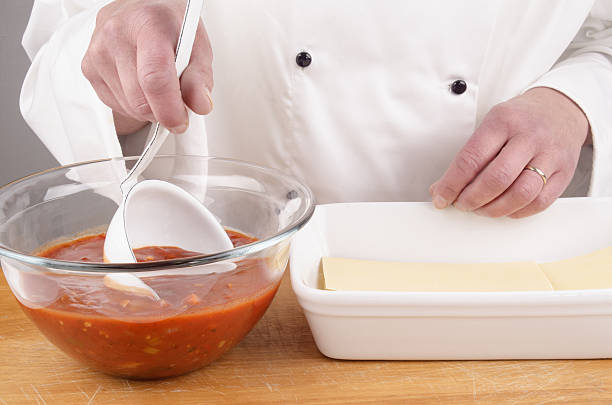 istock tomato sauce in a kitchen ladle 164090378
