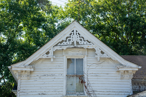The gable field of an old Victorian-era building has a detailed vergeboard.