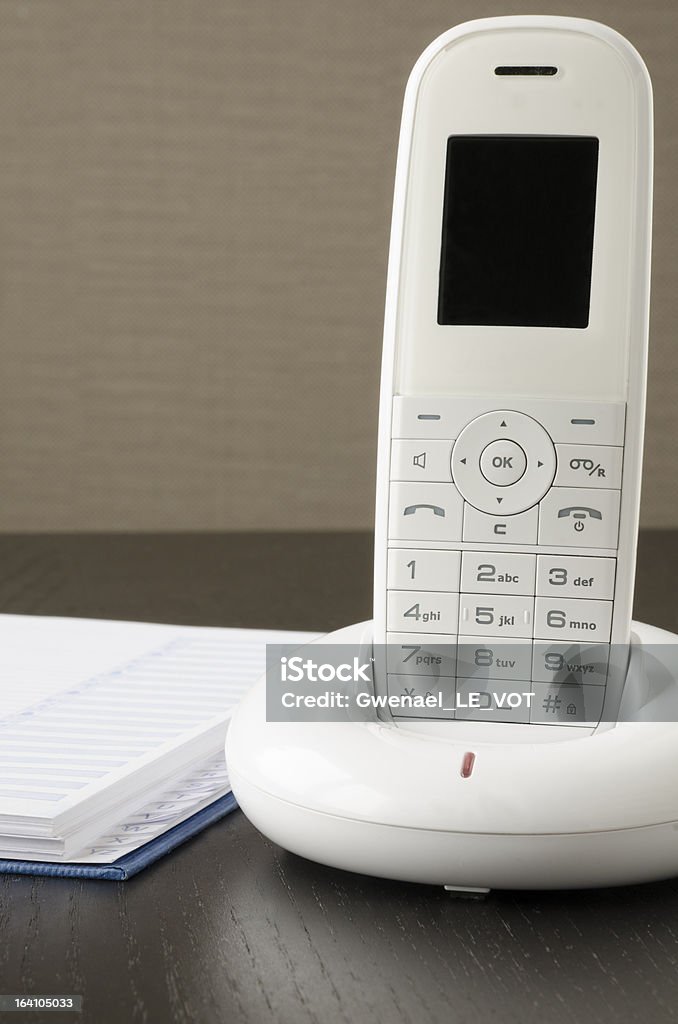 Close-up de um telefone sem fio na escrivaninha - Foto de stock de Caderno de Anotação royalty-free