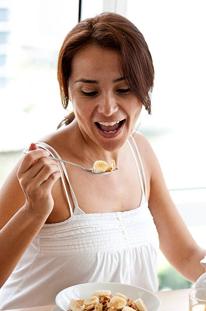 istock Hispanic mature woman having breakfast 164105145