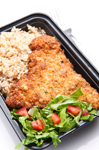 istock Chicken Schnitzel with brown rice and salad 164106386