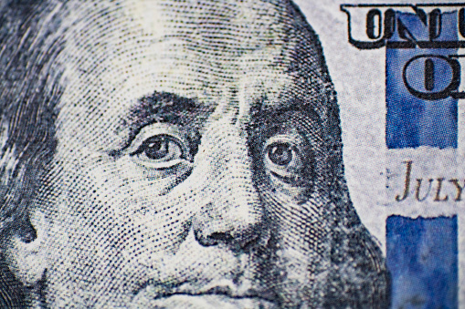 Close up of Benjamin Franklin face on US 100 dollar bill