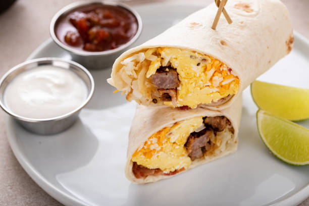 istock Breakfast burritos with scrambled eggs, sausage, cheese and potatoes 1641083225