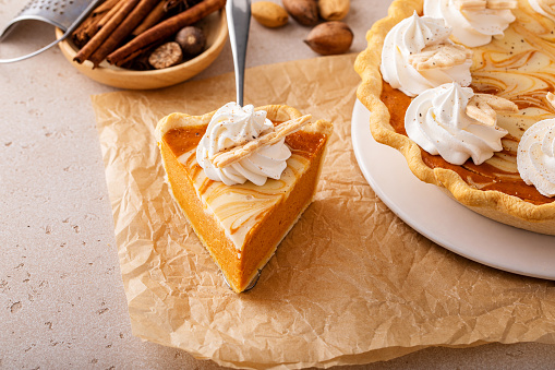 Pumpkin pie with cheesecake swirl, traditional dessert variation for Thanksgiving