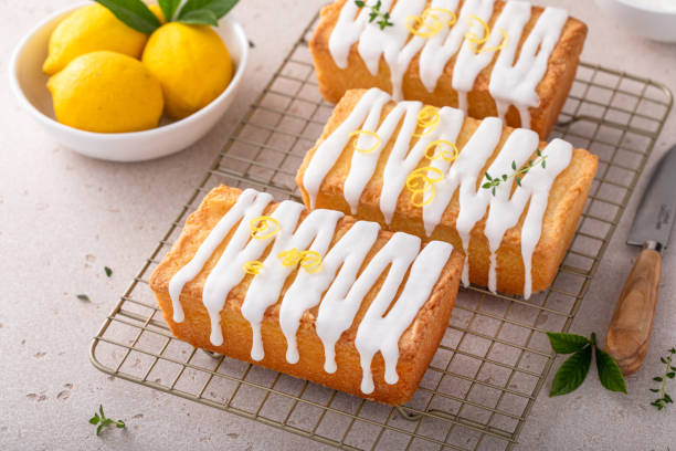 istock Classic lemon pound cake with powdered sugar glaze dripping over 1641095797