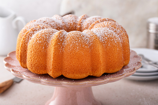 Pound cake baked in a bundt pan, traditional vanilla or sour cream flavor, dusted with powdered sugar