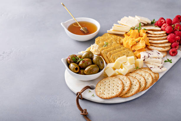 istock Cheese board or snack board with crackers, cheese, olives and berries 1641096503