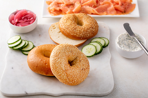Freshly baked bagels served with dill cream cheese, salmon and cucumbers