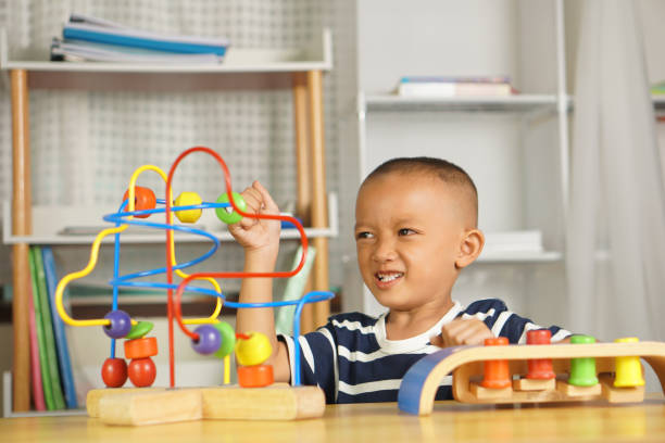 istock Boy playing with developmental toys on table at home 1641098679