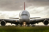 Airbus A380 airliner under cloudy skies