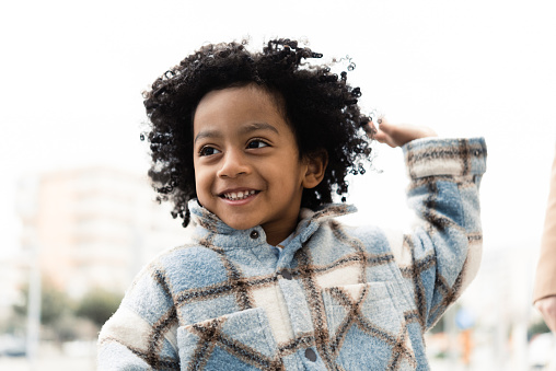 Portrait of a cute African American little boy playing outdoors
