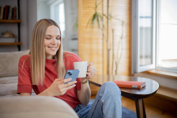 istock Happy young woman using phone 1641121430