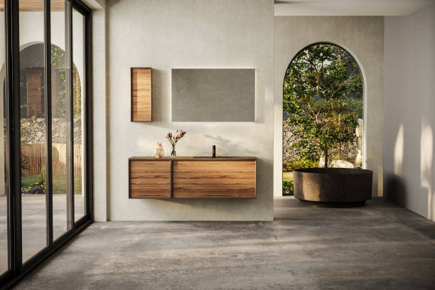 istock Modern bathroom with marble basin, vanity and round mirror, a round bathtub, and a sleek concrete floor. The natural light, back yard. 1641122978