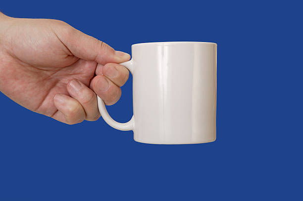 istock Hand holding a coffee mug on bluescreen chromakey 164113328
