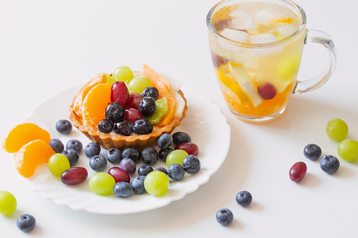 cupcakes with fruits and cold healthy drink on white  table