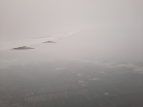 Airplane window on a cloudy day