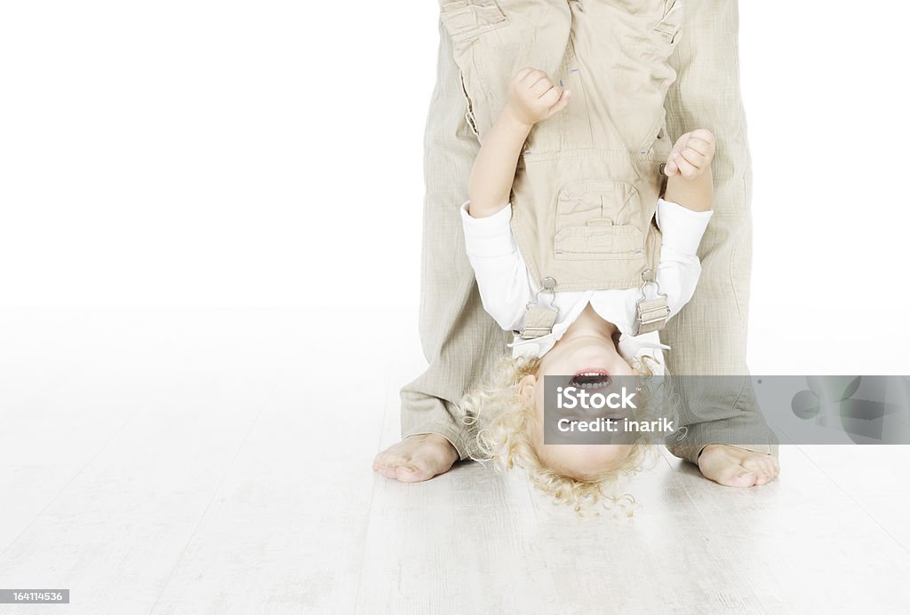 Child standing head over heels Child standing head over heels. Funny up portrait over white background Barefoot Stock Photo