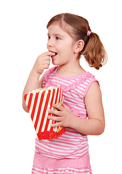 istock hungry little girl eat popcorn 164114574
