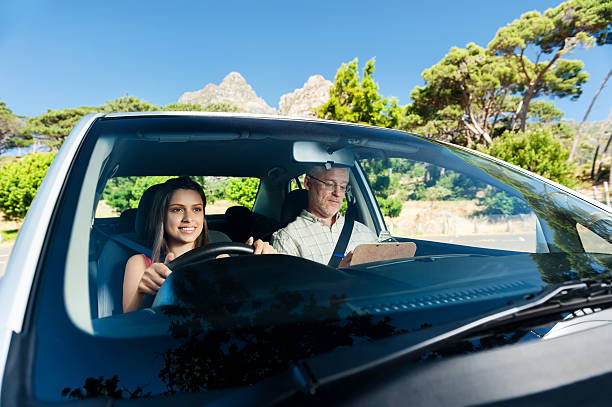 istock Smiling woman taking her driving test with male instructor 164117541