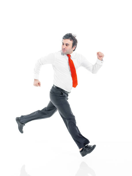 Businessman running fast. Businessman running away from danger behind him in studio.