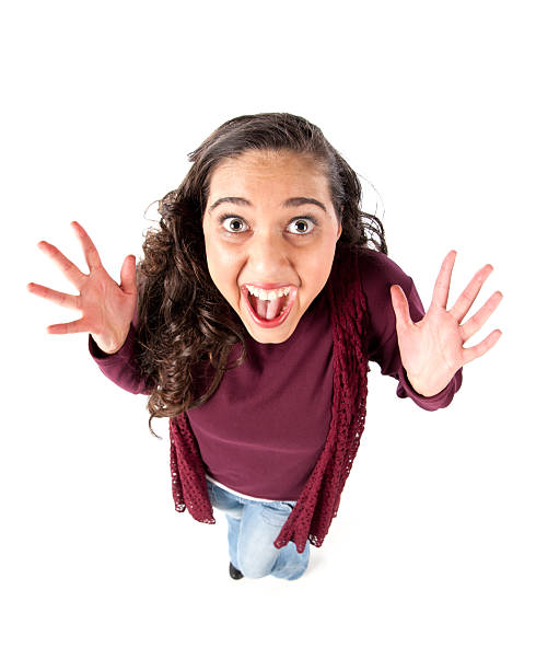 Fisheye Caricature of an Elated Teenage Girl A humorous fisheye caricature of an elated teenage girl celebrating success. fish eye lens photos stock pictures, royalty-free photos & images