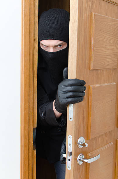 istock Burglar in mask breaking into the house 164120957