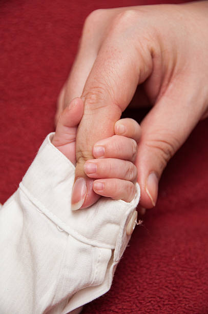 istock Baby's hand with mama's finger 164122422