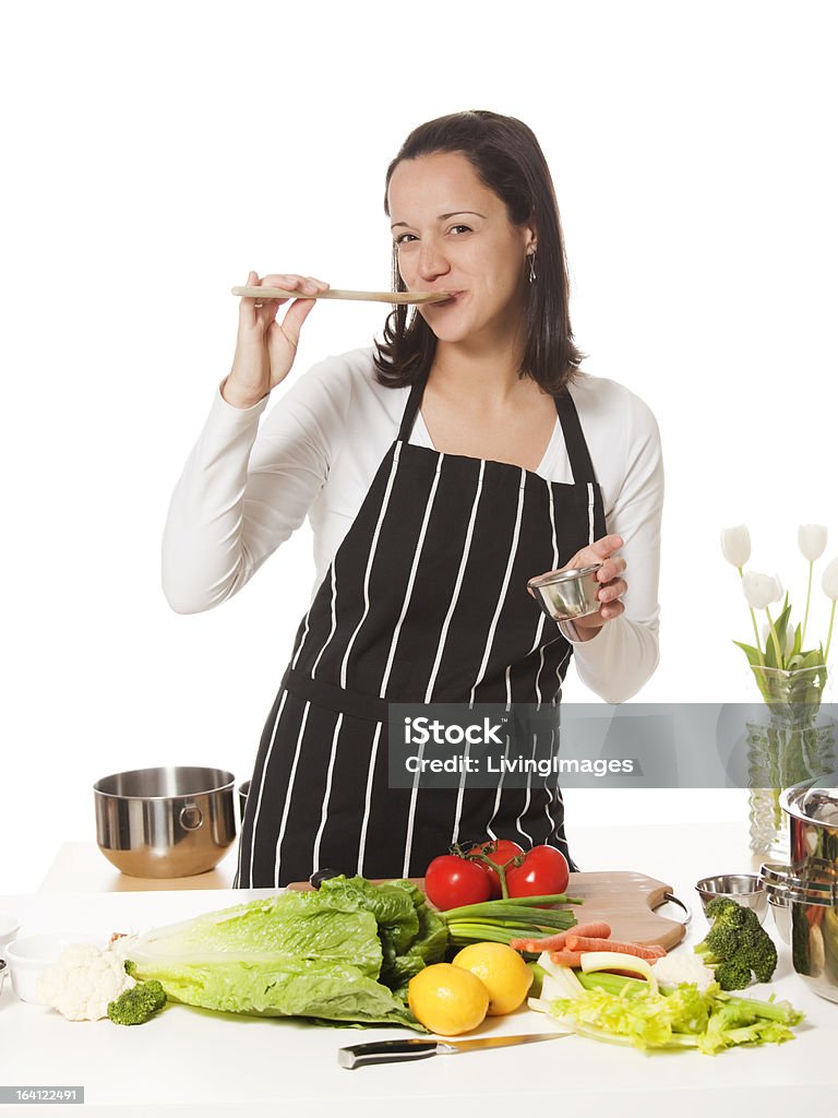 Cook Female cook having a taste. Adult Stock Photo