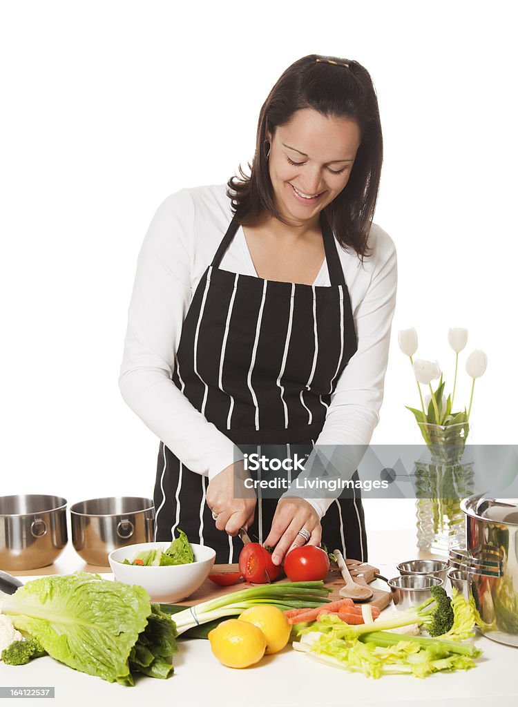 Cook Female cook chopping vegetables. Adult Stock Photo