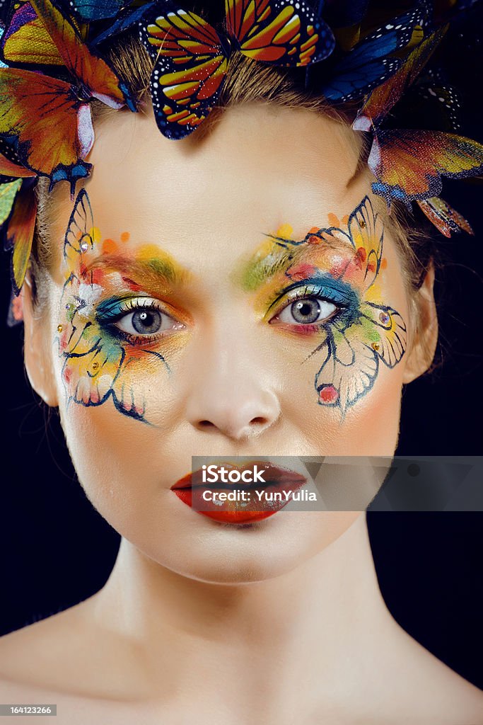 young woman with creative make up like butterfly young woman with creative make up like butterfly on black background Blue Stock Photo
