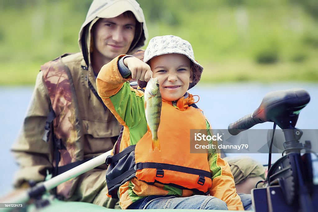 Father and son fishing Happy boy catches his first fish Fishing Stock Photo