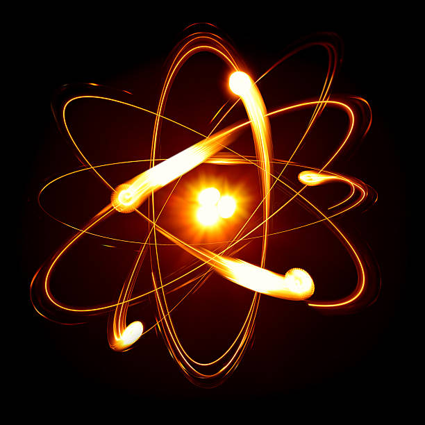 An atom made up of moving fire like balls Symbol of atom over black background electron photos stock pictures, royalty-free photos & images