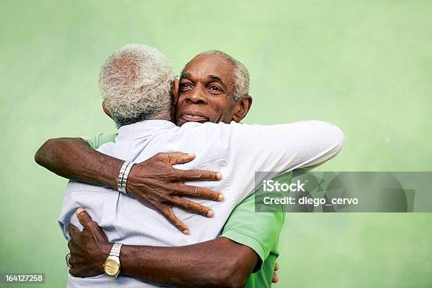 Old Friends Two Senior African American Men Meeting And Hugging Stock Photo - Download Image Now