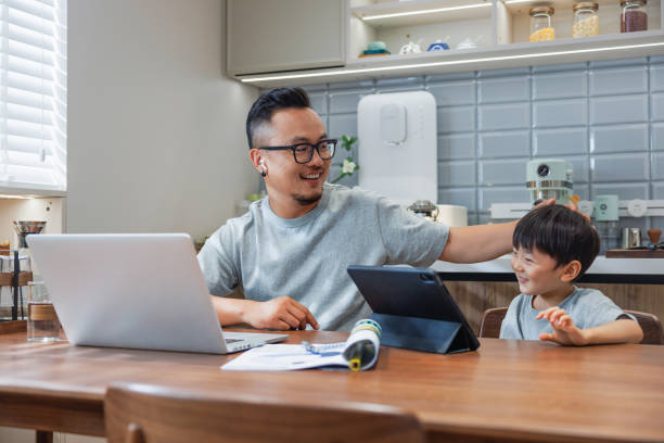 istock asian father plays with his son while working at home 1641283595